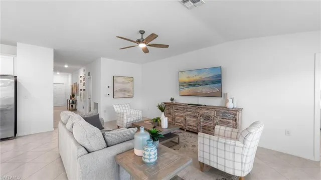 a living room with furniture and kitchen view