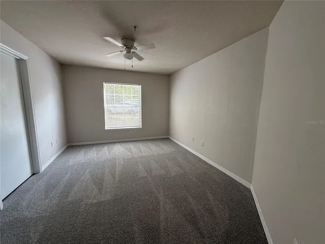 an empty room with a empty space and windows