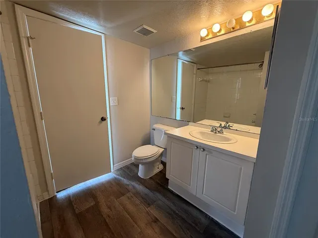 a bathroom with a sink a toilet and mirror