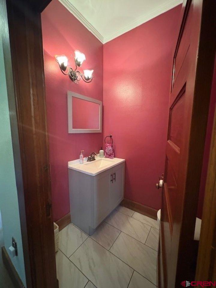 184 Garnet Avenue Delta, CO 81416 - Photo 16 of 36 a bathroom with a sink mirror and vanity