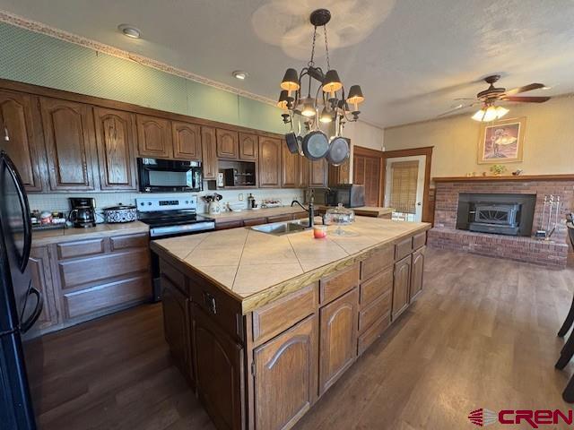 184 Garnet Avenue Delta, CO 81416 - Photo 18 of 36 a kitchen with kitchen island granite countertop a sink a counter top space stainless steel appliances and cabinets