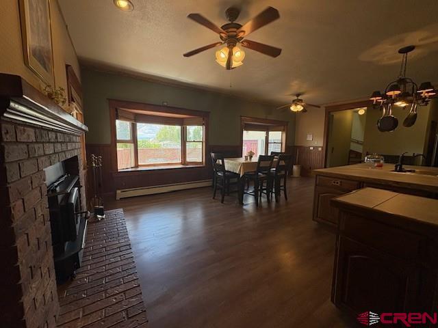 184 Garnet Avenue Delta, CO 81416 - Photo 19 of 36 a dining room with wooden floor a chandelier a glass table and chairs