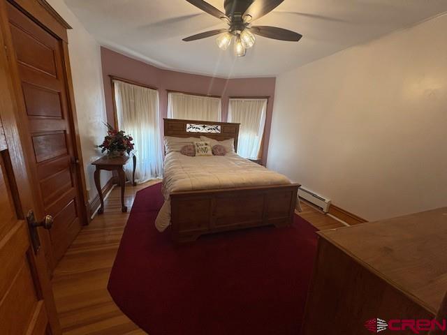 184 Garnet Avenue Delta, CO 81416 - Photo 23 of 36 a bedroom with a bed and a chandelier
