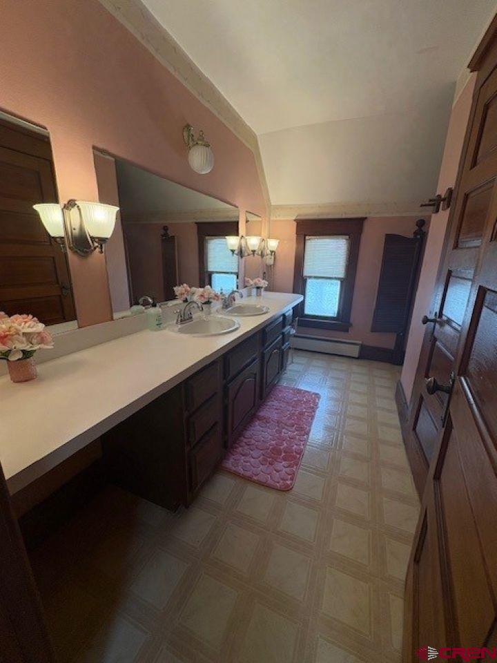 184 Garnet Avenue Delta, CO 81416 - Photo 25 of 36 a spacious bathroom with a bathtub sink and mirror