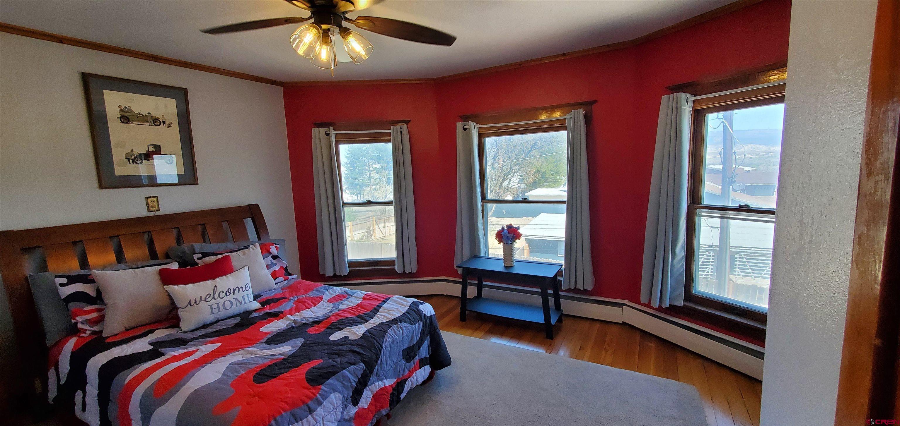 184 Garnet Avenue Delta, CO 81416 - Photo 27 of 36 a bed sitting in a bedroom next to a window
