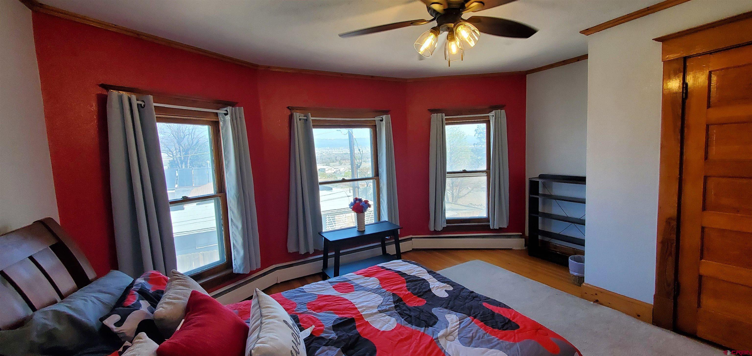184 Garnet Avenue Delta, CO 81416 - Photo 28 of 36 a bedroom with a bed and a chandelier