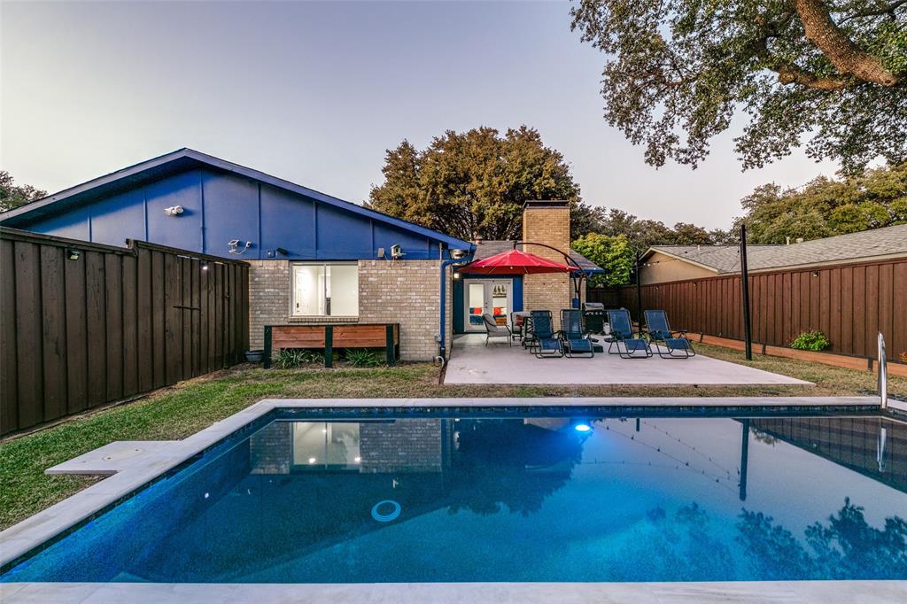 a view of house with backyard outdoor seating and entertaining space