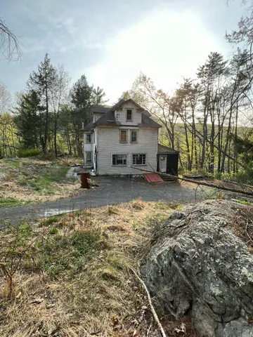 a view of a porch with a table and chairs