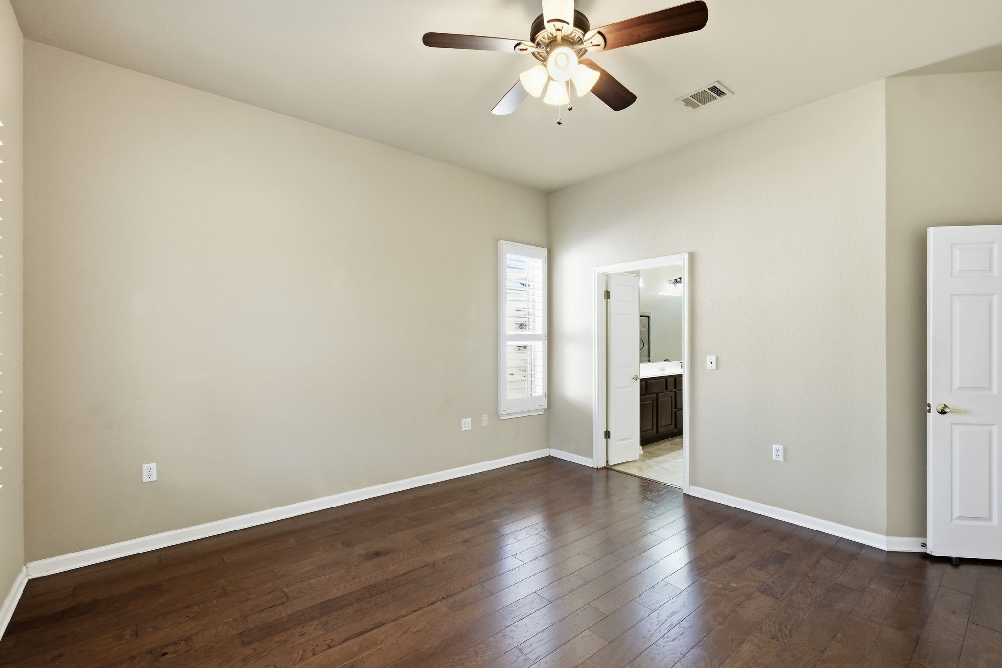 196 Whispering Wind Drive Georgetown, TX 78633 - Photo 14 of 34 an empty room with wooden floor and ceiling fan