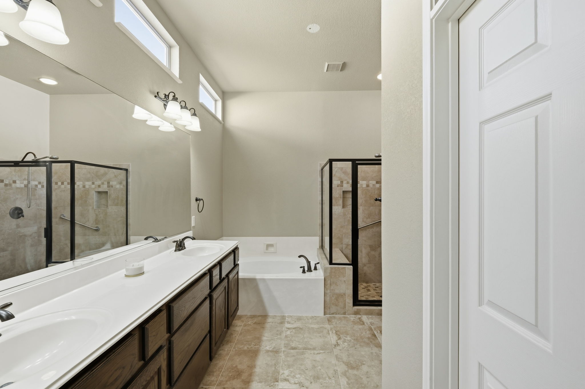 196 Whispering Wind Drive Georgetown, TX 78633 - Photo 16 of 34 a spacious bathroom with a double vanity sink a large mirror and shower