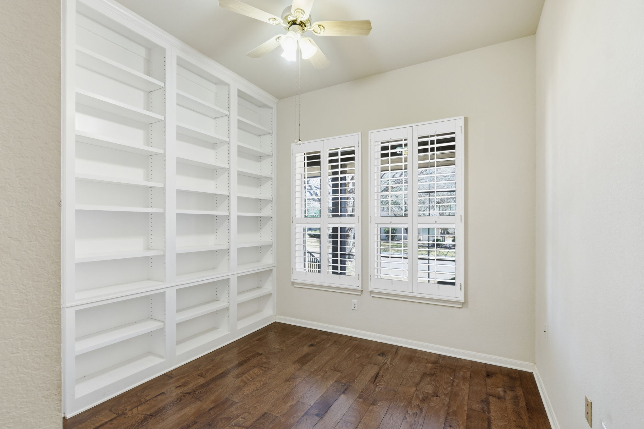 196 Whispering Wind Drive Georgetown, TX 78633 - Photo 23 of 34 a view of an empty room with a window and wooden floor