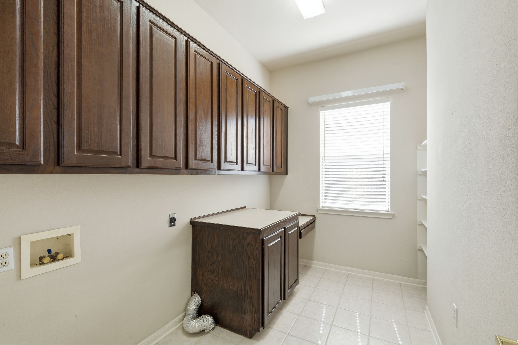 196 Whispering Wind Drive Georgetown, TX 78633 - Photo 24 of 34 a room with stainless steel appliances wooden cabinets and a window