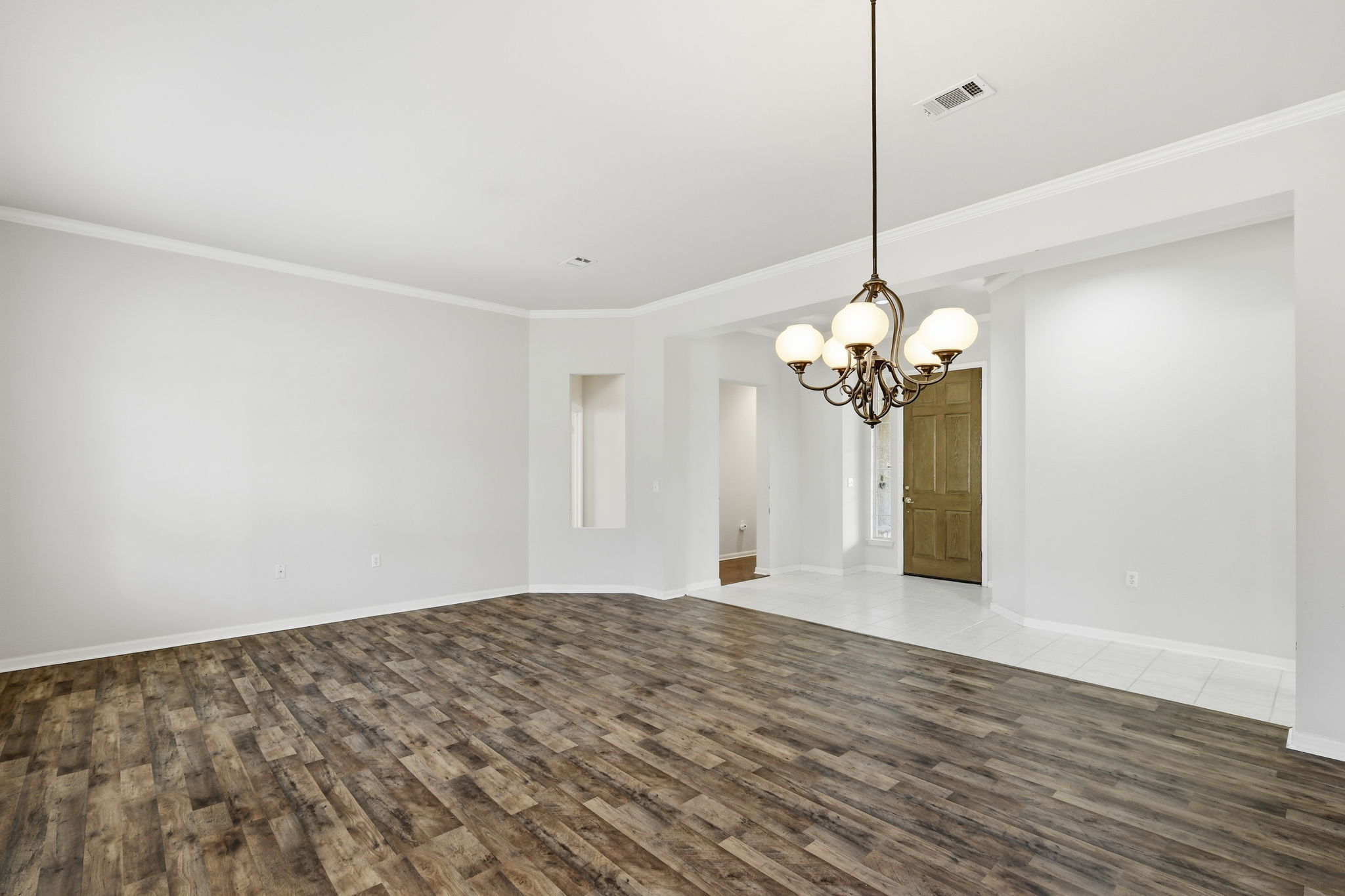 196 Whispering Wind Drive Georgetown, TX 78633 - Photo 4 of 34 a view of a room with a chandelier fan and wooden floor