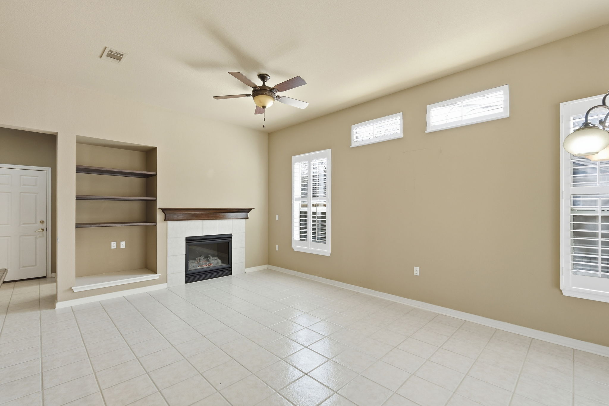 196 Whispering Wind Drive Georgetown, TX 78633 - Photo 5 of 34 a view of an empty room with a fireplace and a window