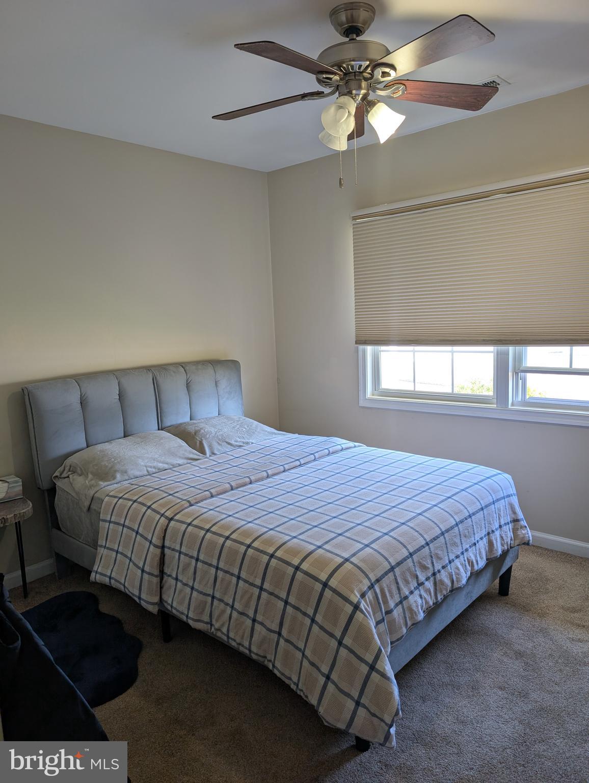335 Cherry Hill Boulevard Cherry Hill, NJ 08002 - Photo 12 of 17 a bedroom with a bed and a chandelier