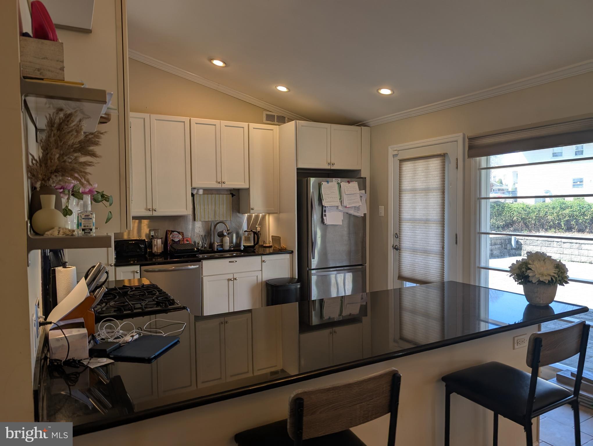 335 Cherry Hill Boulevard Cherry Hill, NJ 08002 - Photo 7 of 17 a kitchen with a refrigerator and white cabinets