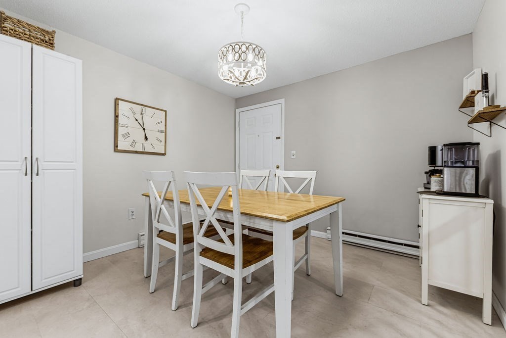 10 Erick Road, Unit 42 Mansfield, MA 02048 - Photo 12 of 33 a view of a dining room with furniture and wooden floor