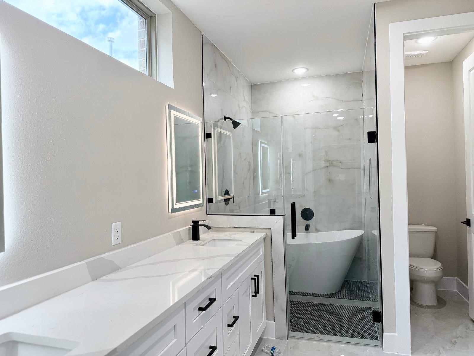 2518 Liguria Ln Spring Spring, TX 77388 - Photo 17 of 36 a bathroom with a double vanity sink toilet a mirror and shower