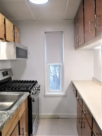 a kitchen with stainless steel appliances granite countertop a sink stove and cabinets