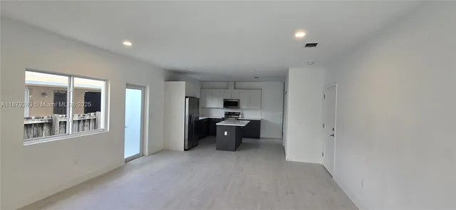 a kitchen with a sink and a refrigerator