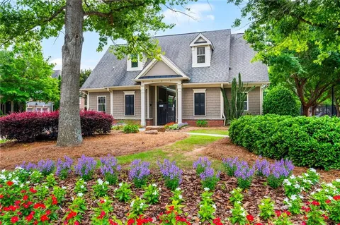 a front view of a house with a yard and fountain