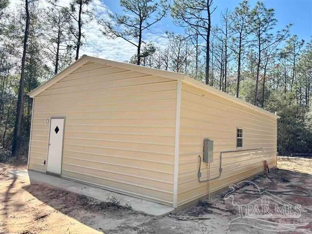 a view of a wooden house with large trees