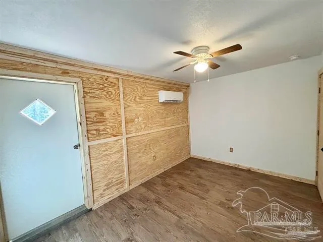 an empty room with closet and windows