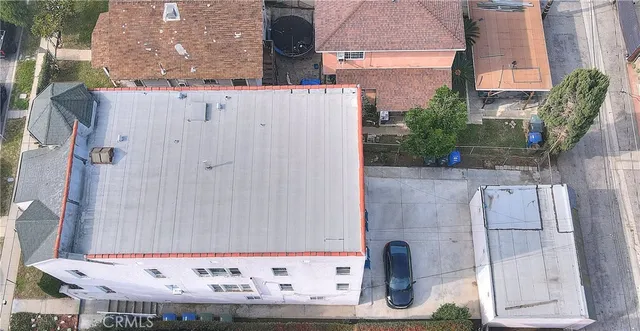 an aerial view of residential houses with city view
