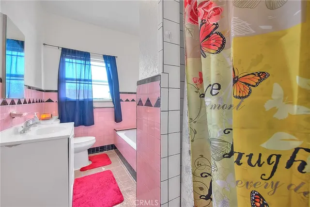 a living room with furniture and a book shelf