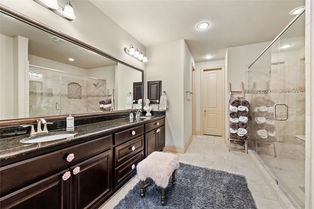 a large kitchen with kitchen island granite countertop a sink and cabinets