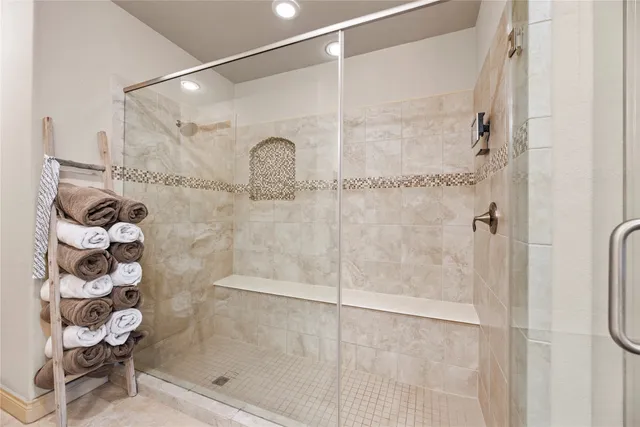 a bathroom with a glass shower door