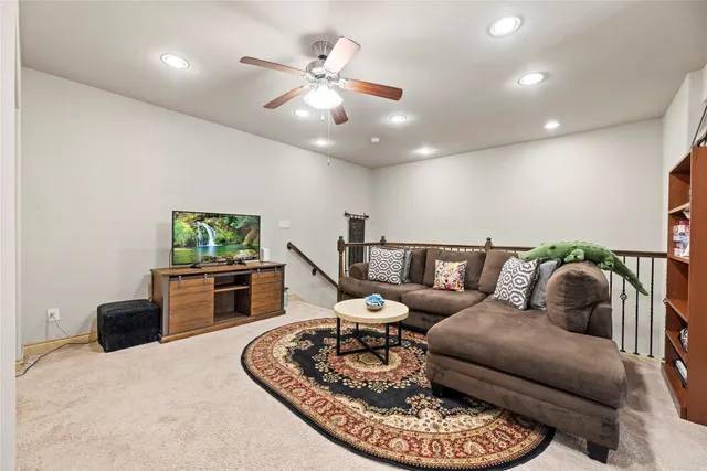 a view of a hallway with workspace and a window