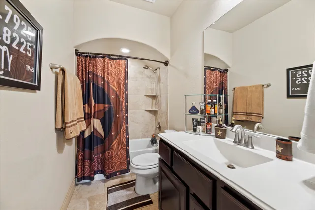 a bed sitting in a bedroom next to a window and a chandelier