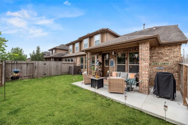 a front view of a house with a yard table and chairs