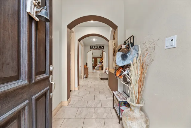 a view of a entryway door with a hallway