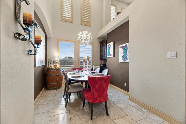 a view of a dining room with furniture and a chandelier