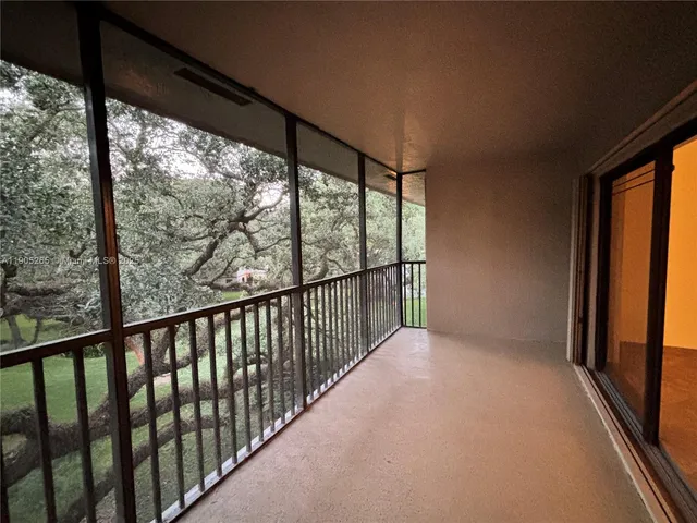 a kitchen with stainless steel appliances granite countertop a refrigerator a sink dishwasher a oven a large island with wooden cabinets and floor