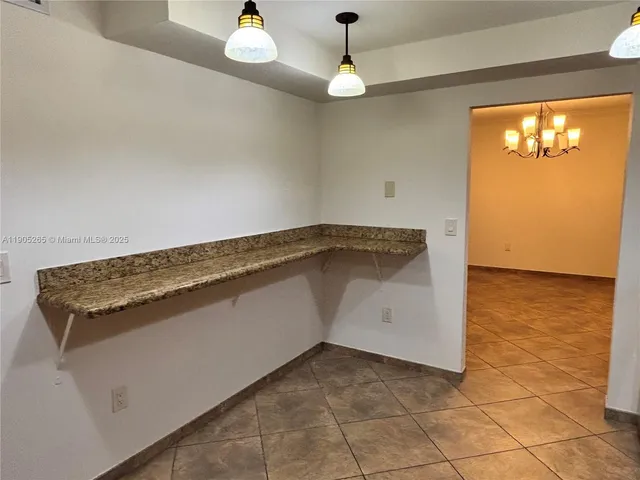a view of an empty room and wooden floor