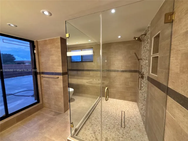 a bathroom with a shower and a sink