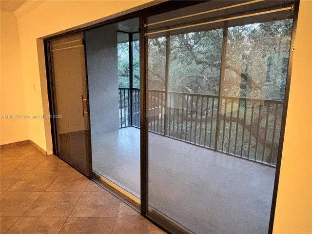 a view of a glass door and the balcony