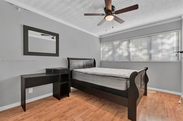 a bedroom with a bed and a desk