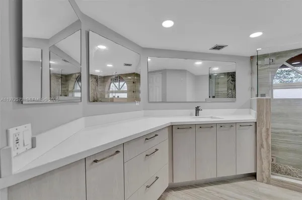 a view of a kitchen with a sink stainless steel appliances and cabinets