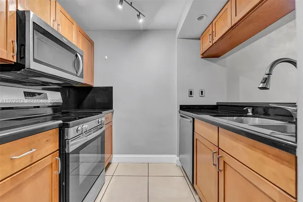 a kitchen with stainless steel appliances granite countertop a stove and a microwave