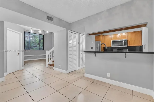 a view of a livingroom with bathroom and window