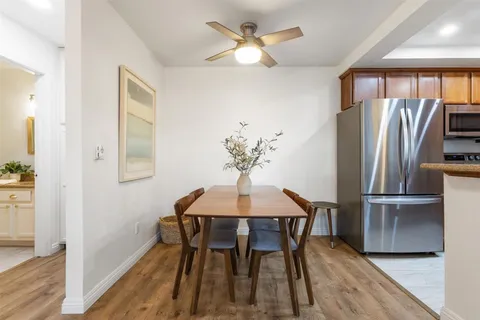 a dining room with furniture a chandelier and wooden floor