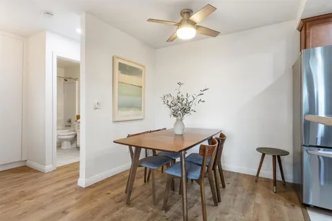 a dining room with furniture and window