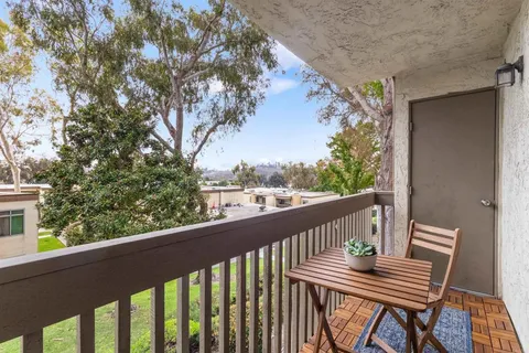 a view of balcony with wooden floor and fence