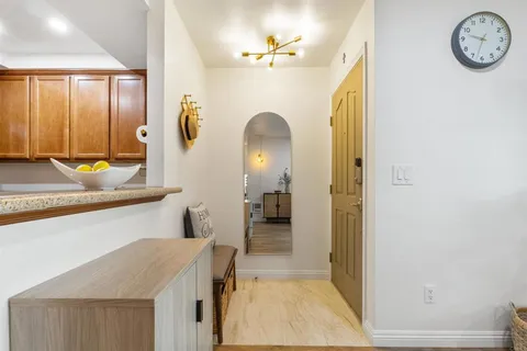 a view of a hallway to a livingroom with furniture
