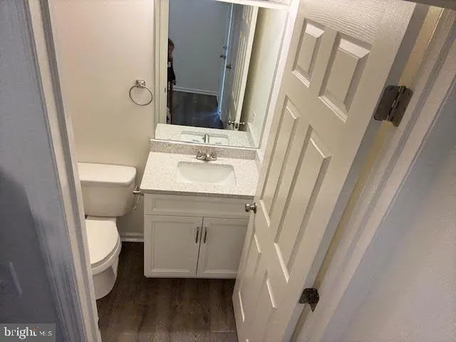 a bathroom with a sink toilet and a mirror