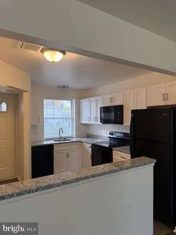 a kitchen with stainless steel appliances a stove sink microwave and refrigerator